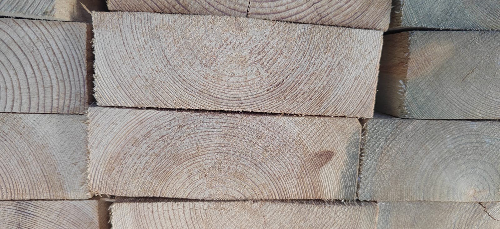 Ends of stacked lumber boards